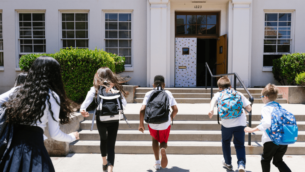 Kids running into school classroom