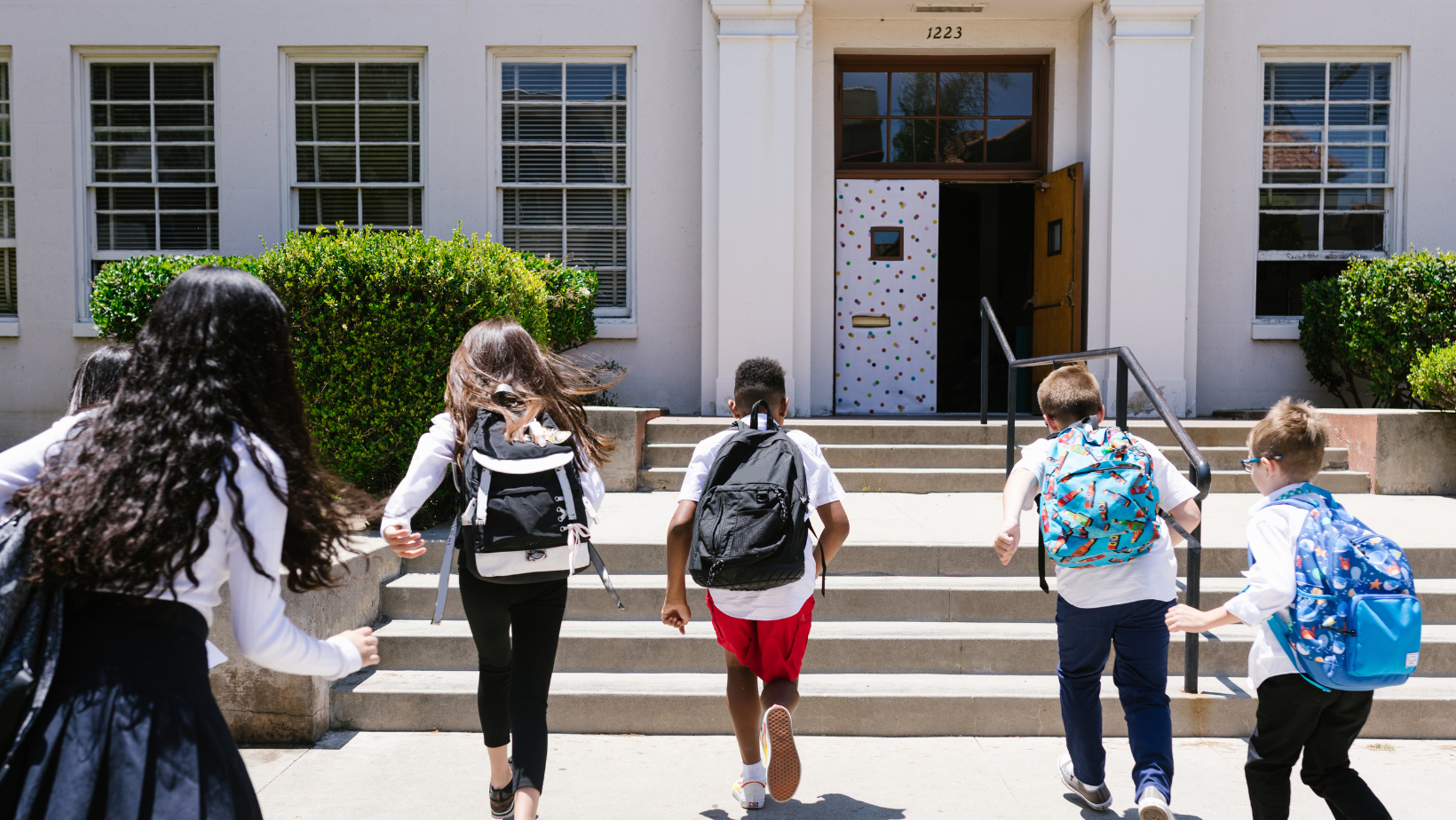 Kids running into school classroom