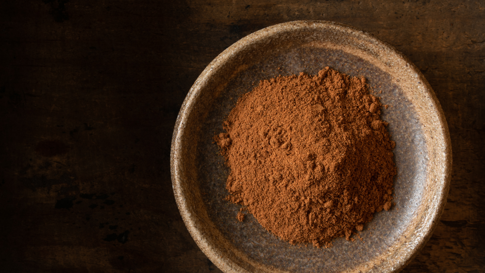 ground cinnamon in a bow.l